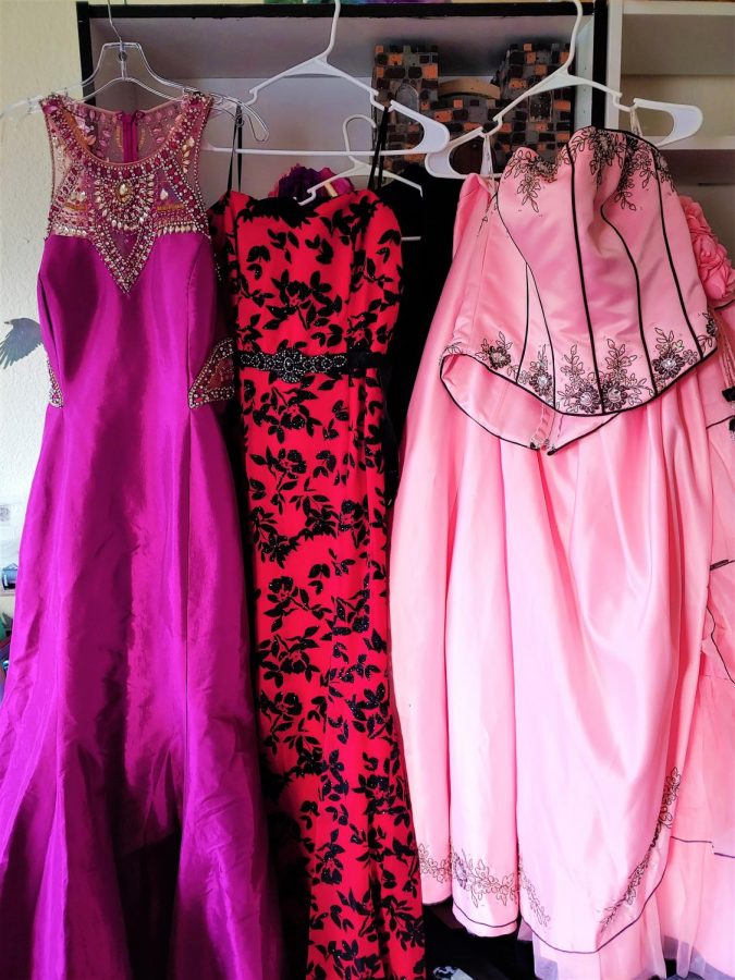 All different prom dresses that are still nice they purple is from a family friend, the red is a dress from Ross, and the pink is from a formal dress shop.