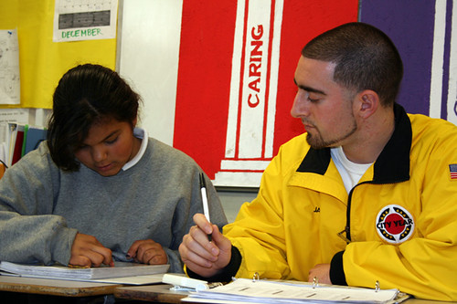 A student is being tutored and getting help with an assignment.