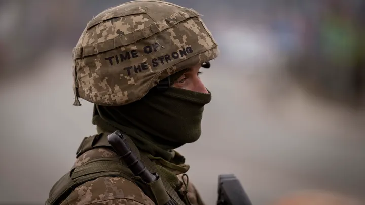 A Ukrainian soldier stands guard at a checkpoint on the outskirts of Kyiv, Ukraine.