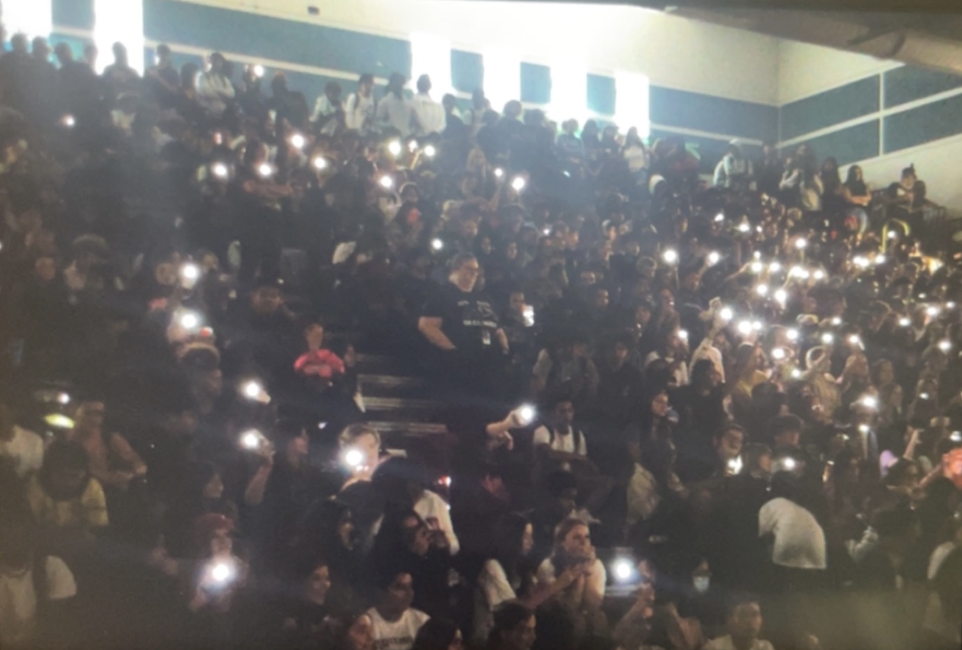 The student section of the assembly flashing their lights in accordance to Tales As Old As Time